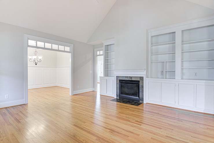 Empty living room with modern shelves and hardwood floors