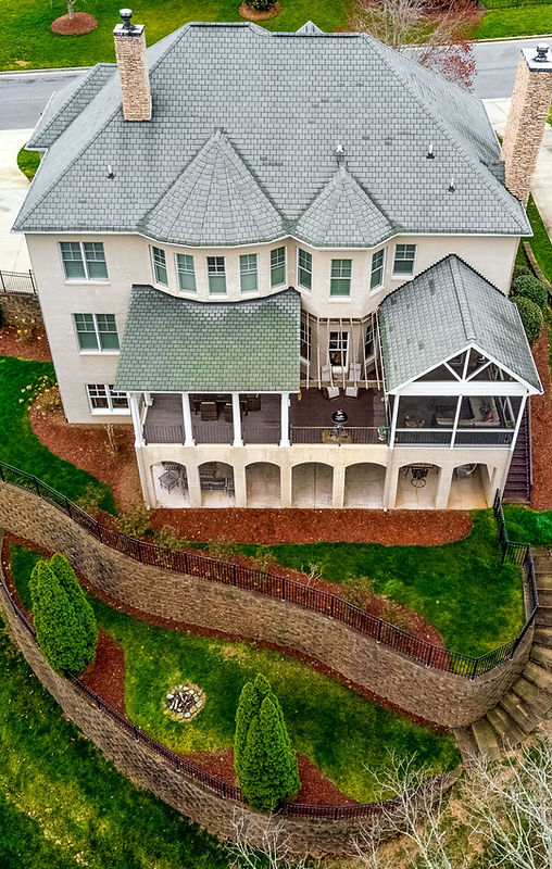 Aerial shot of big house with multi layered lawn