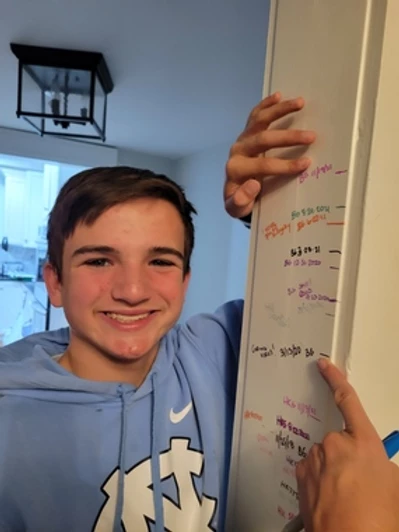 Tori's son marks his height against the wall